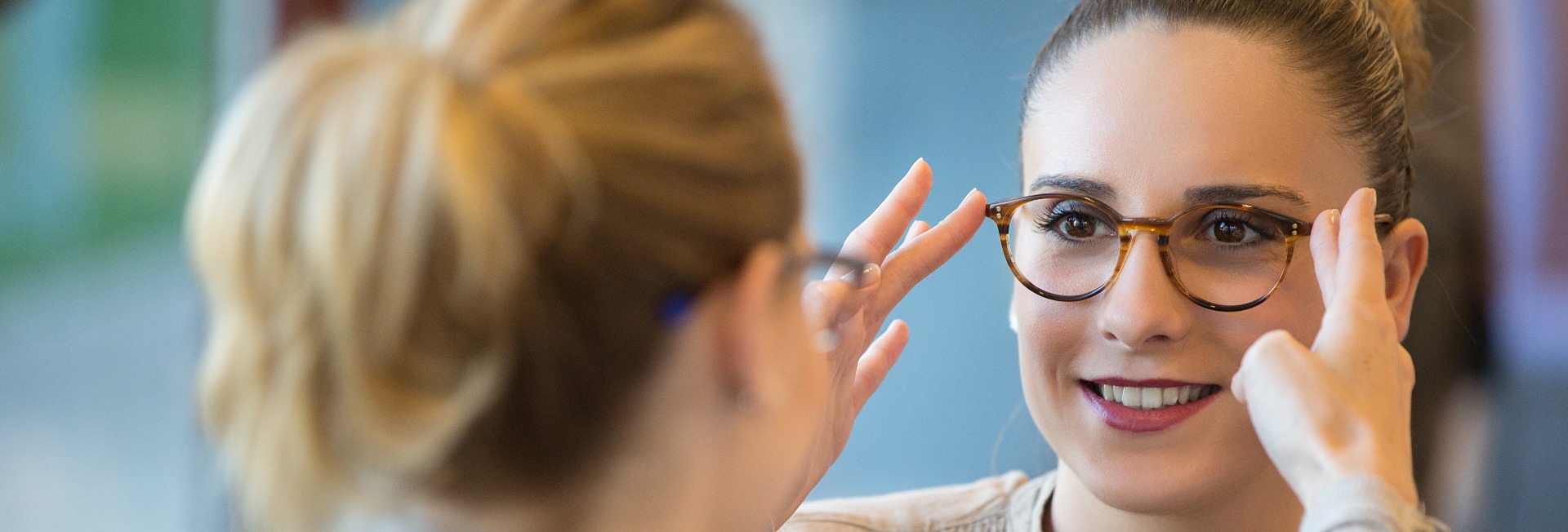 Salesgirl Assisting Customer To In Wearing Glasses
